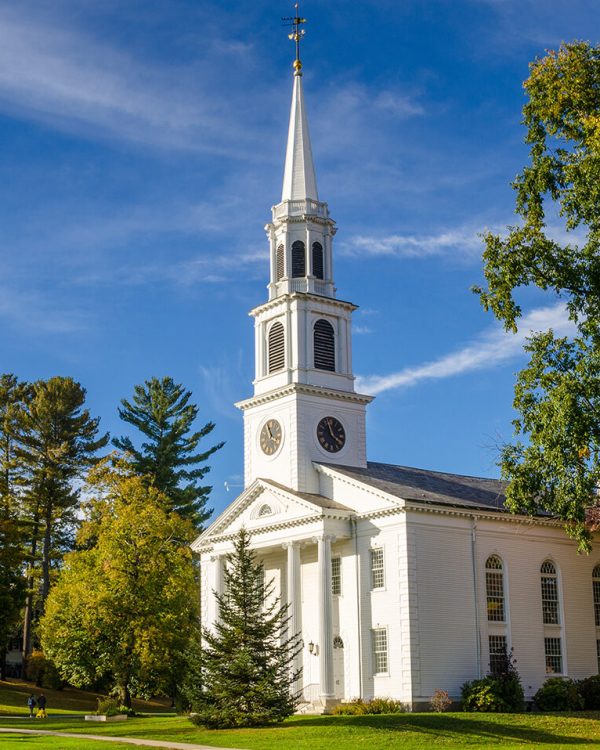 Traditional American White Church with high Steeple under an Autumnal Blue Sky. Williamstown, MA.